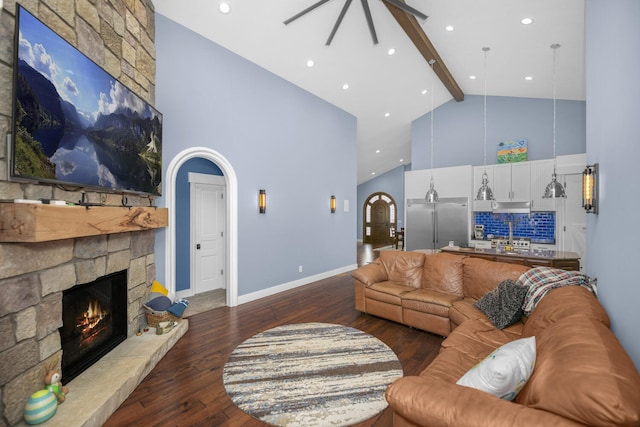 21373 Sail Bay Dr, Cassopolis, MI 49031 - living area with high vaulted ceiling, a ceiling fan, beam ceiling, wood finished floors, and a stone fireplace