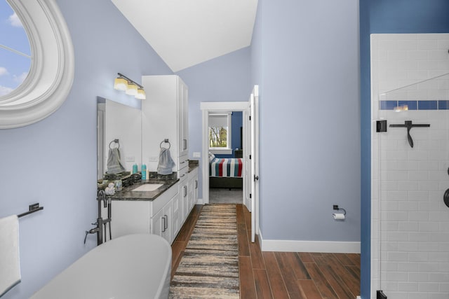 21373 Sail Bay Dr, Cassopolis, MI 49031 - ensuite bathroom featuring vanity, lofted ceiling, wood finished floors, a tile shower, and baseboards