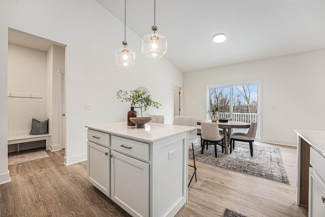 kitchen with a kitchen bar, light countertops, and light wood-type flooring