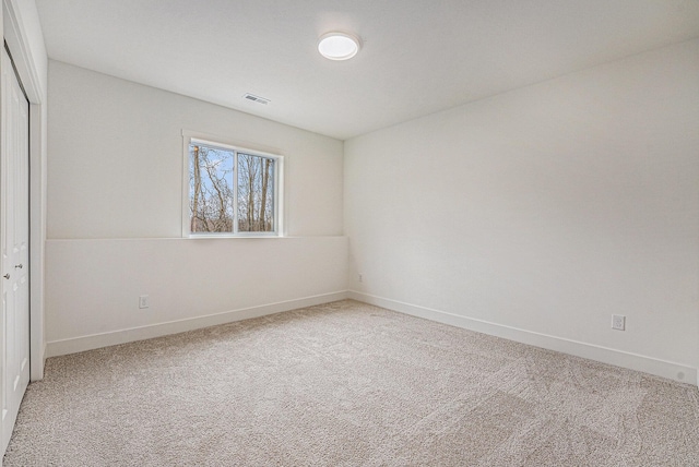 unfurnished bedroom with carpet floors, a closet, baseboards, and visible vents