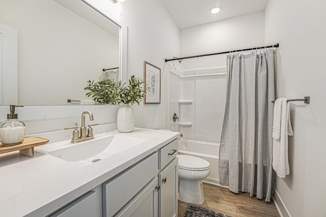 bathroom featuring shower / tub combo, toilet, vanity, and wood finished floors
