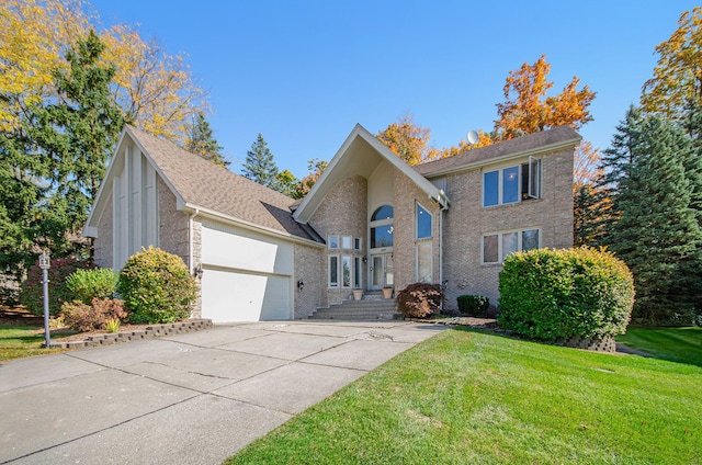 28909 Hidden Trl, Farmington Hills, MI 48331 - traditional-style house featuring an attached garage, concrete driveway, a front lawn, and brick siding