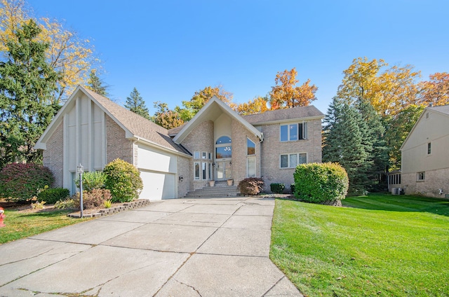 28909 Hidden Trl, Farmington Hills, MI 48331 - view of front of home featuring brick siding, a garage, concrete driveway, and a front lawn