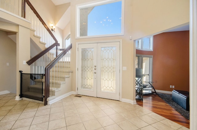 28909 Hidden Trl, Farmington Hills, MI 48331 - tiled entrance foyer with french doors, a high ceiling, stairs, and baseboards