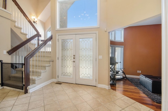 28909 Hidden Trl, Farmington Hills, MI 48331 - entrance foyer featuring a high ceiling, tile patterned flooring, stairs, french doors, and baseboards