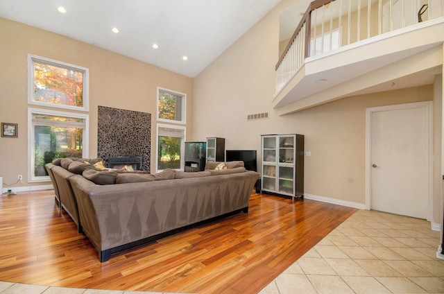 28909 Hidden Trl, Farmington Hills, MI 48331 - living area with a high ceiling, a tile fireplace, light wood-type flooring, baseboards, and recessed lighting