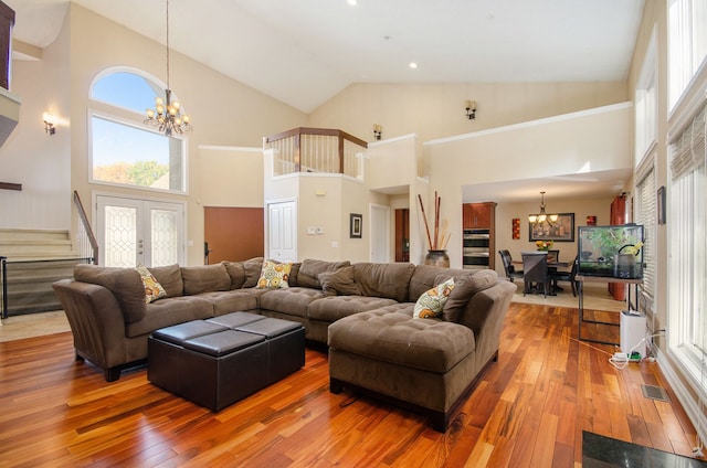 28909 Hidden Trl, Farmington Hills, MI 48331 - living room with a chandelier, hardwood / wood-style flooring, high vaulted ceiling, stairs, and recessed lighting
