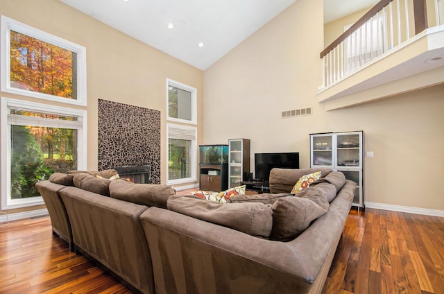28909 Hidden Trl, Farmington Hills, MI 48331 - living area with high vaulted ceiling, a tile fireplace, hardwood / wood-style flooring, baseboards, and recessed lighting