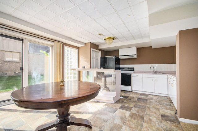 28909 Hidden Trl, Farmington Hills, MI 48331 - kitchen featuring range with electric stovetop, a sink, white cabinetry, freestanding refrigerator, and light countertops