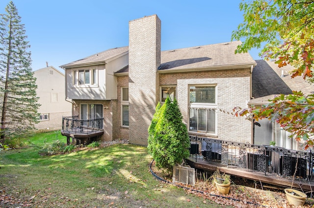 28909 Hidden Trl, Farmington Hills, MI 48331 - back of property featuring a chimney, brick siding, a wooden deck, a yard, and roof with shingles
