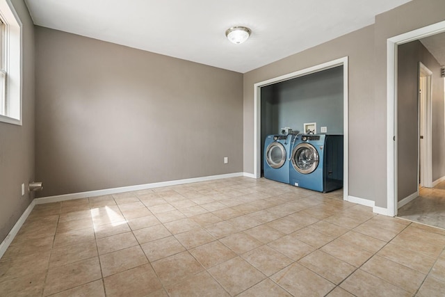 laundry room with baseboards, washer hookup, light tile patterned floors, and laundry area