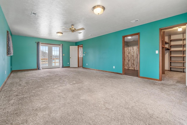 interior space with baseboards, visible vents, carpet floors, and ceiling fan