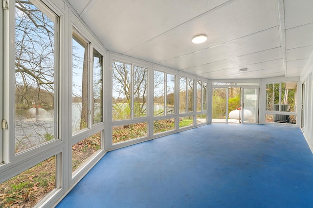 unfurnished sunroom with a water view