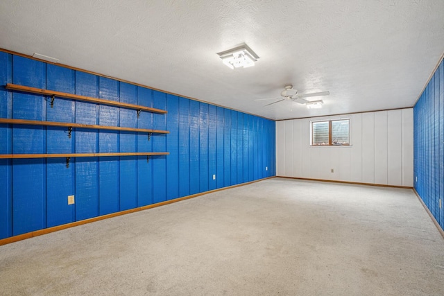 empty room featuring baseboards, carpet flooring, a textured ceiling, and ceiling fan