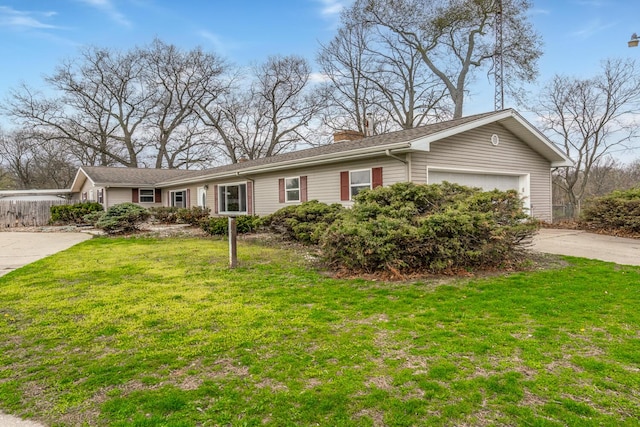single story home featuring a chimney, driveway, a garage, and a front yard