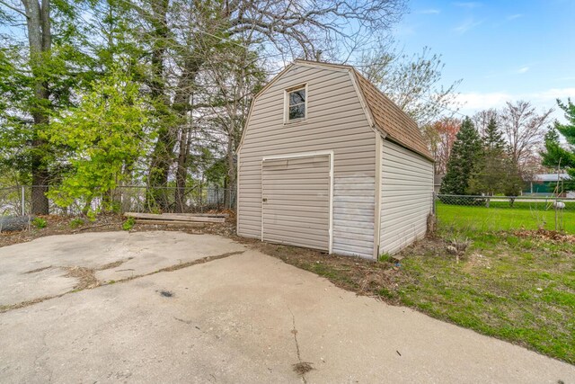 garage with fence and a garage