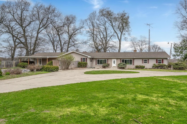 ranch-style home featuring a chimney, fence, a front yard, and curved driveway