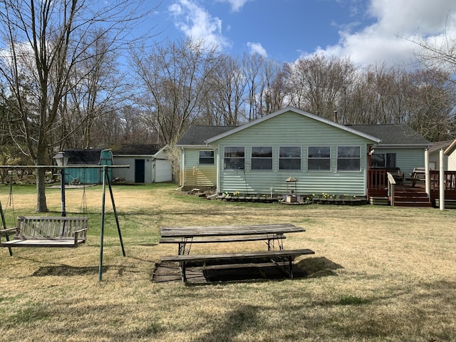 1026 Lakeview Dr, Brooklyn, MI 49230 - rear view of house with a wooden deck, a lawn, a storage shed, and an outdoor structure