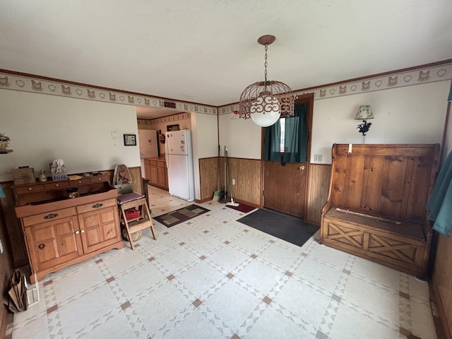 1026 Lakeview Dr, Brooklyn, MI 49230 - dining space with wainscoting, wood walls, and a notable chandelier