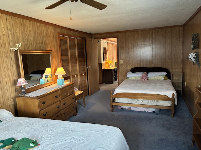 1026 Lakeview Dr, Brooklyn, MI 49230 - carpeted bedroom featuring crown molding, wood walls, and ceiling fan