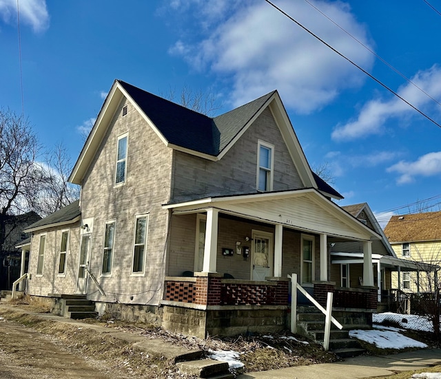 view of front of house with brick siding and covered porch