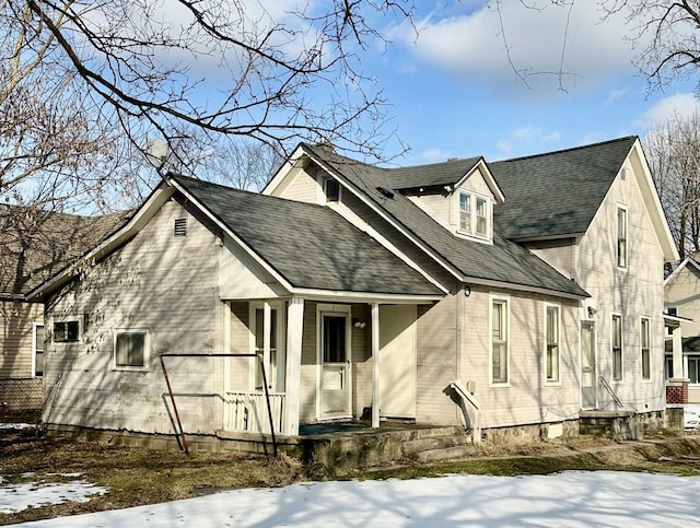 exterior space featuring a shingled roof and covered porch