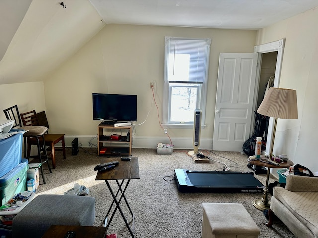 carpeted living room with vaulted ceiling and baseboards