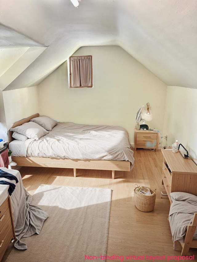 bedroom featuring wood finished floors and lofted ceiling