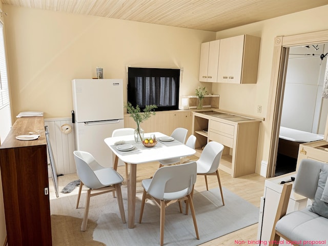 dining space with light wood finished floors and wood ceiling
