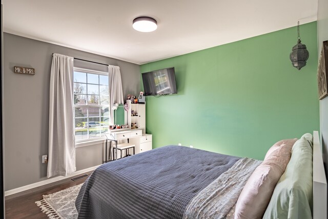 1242 Bay, Holly, MI 48442 - bedroom with visible vents, baseboards, and wood finished floors