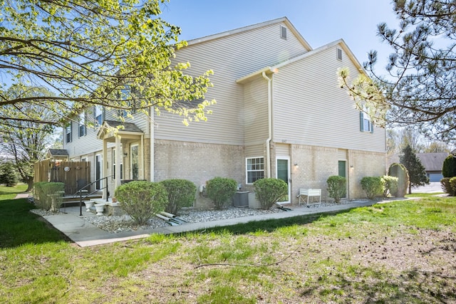 1242 Bay, Holly, MI 48442 - view of home's exterior with a lawn and brick siding
