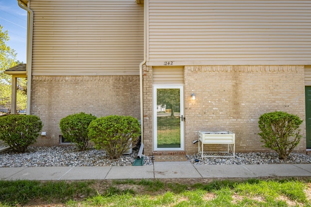 1242 Bay, Holly, MI 48442 - view of exterior entry featuring brick siding