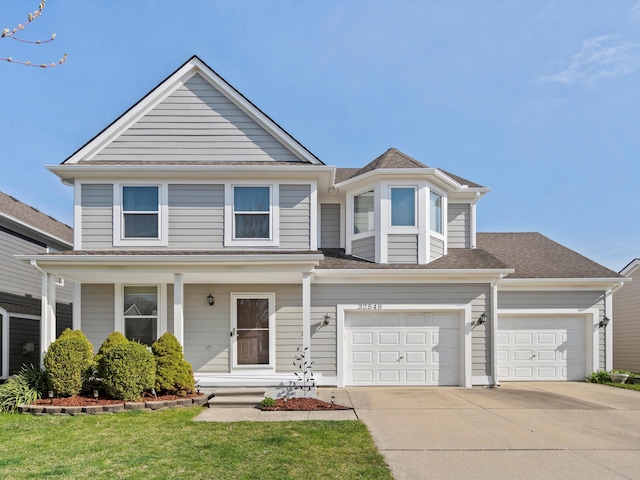 view of front of property with a porch, a shingled roof, driveway, and a front yard