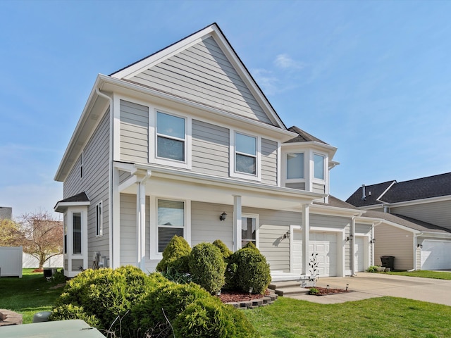 view of front of home featuring a garage, a front lawn, and concrete driveway