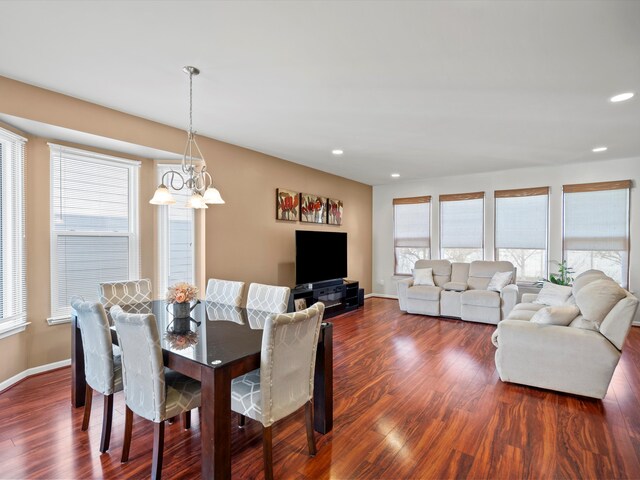 dining room featuring recessed lighting, dark wood finished floors, baseboards, and an inviting chandelier