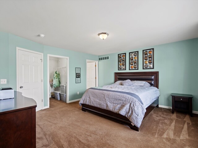 carpeted bedroom featuring visible vents and baseboards
