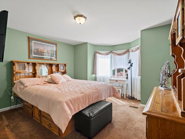 carpeted bedroom with baseboards and visible vents