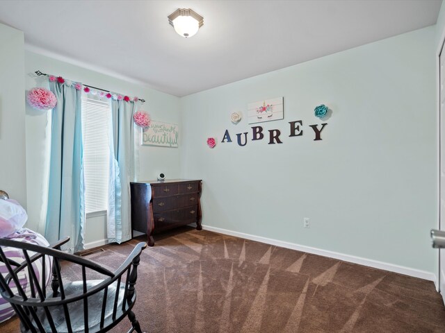 bedroom with carpet floors and baseboards