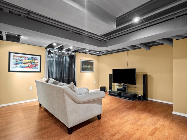 living area featuring light wood-style floors and baseboards