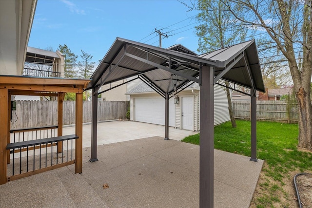 view of patio / terrace featuring an outbuilding, a garage, and fence private yard
