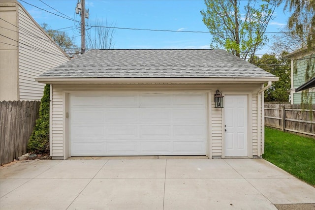 detached garage featuring fence