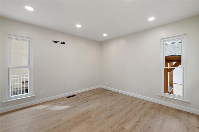 spare room with recessed lighting, visible vents, baseboards, and light wood-style floors