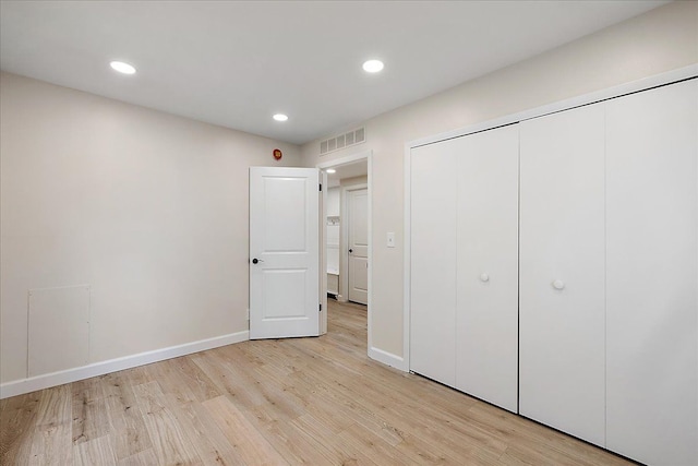unfurnished bedroom with baseboards, visible vents, light wood-style flooring, and recessed lighting