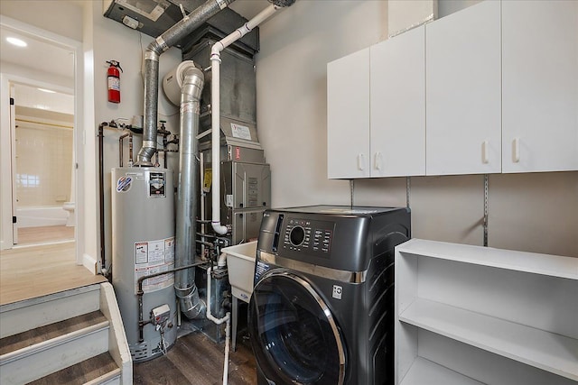 laundry room featuring gas water heater, dark wood-style floors, recessed lighting, cabinet space, and washer / clothes dryer