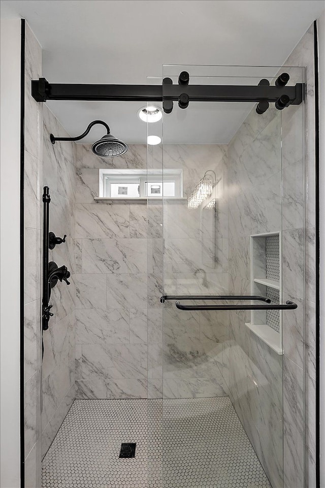 bathroom with a marble finish shower