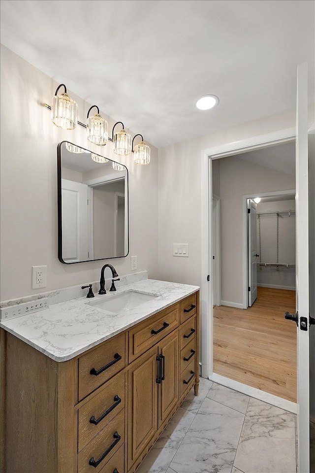 bathroom featuring recessed lighting, a chandelier, vanity, marble finish floor, and baseboards