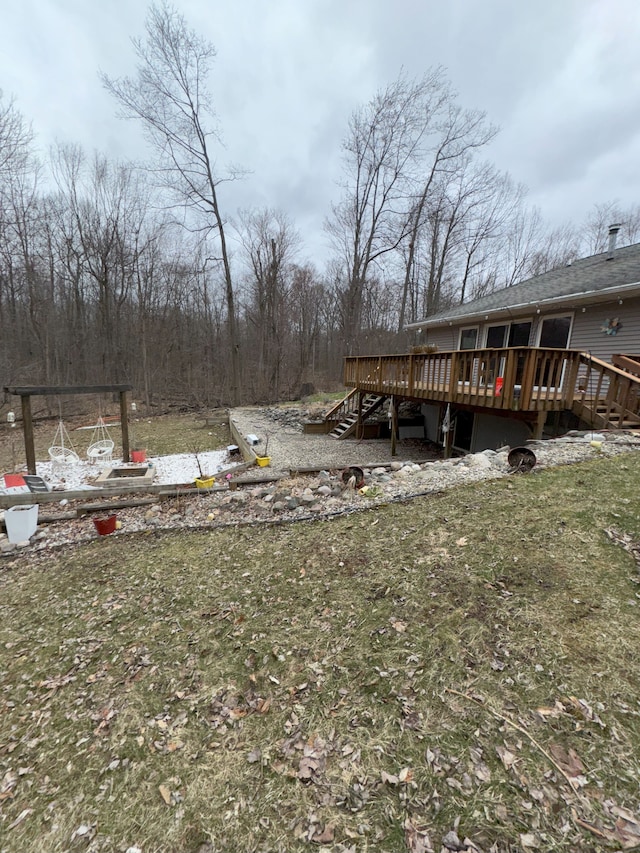 view of yard featuring a wooden deck and stairs