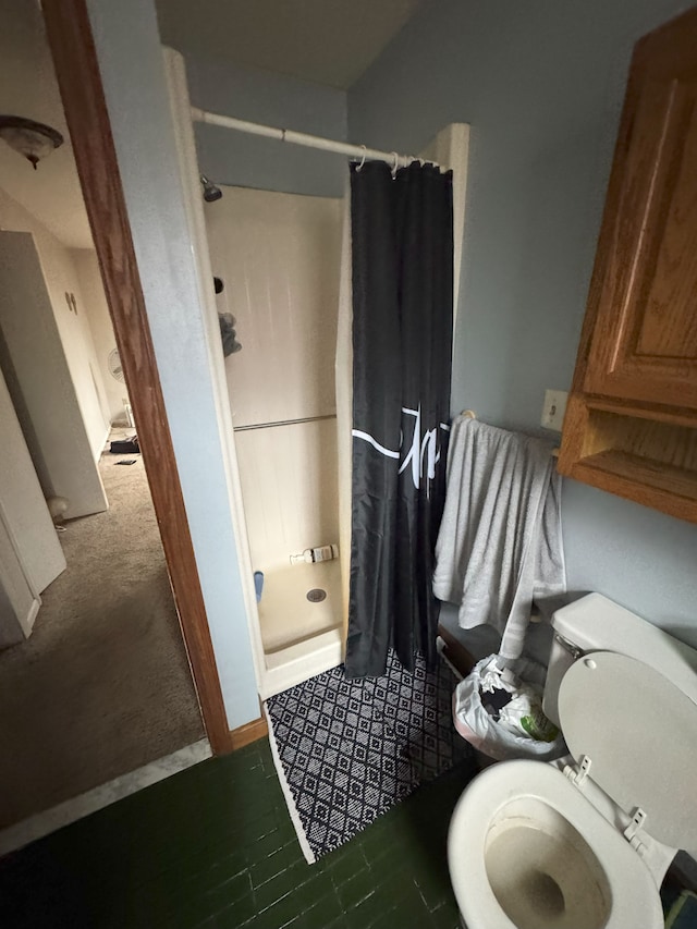 full bathroom with toilet and a shower stall