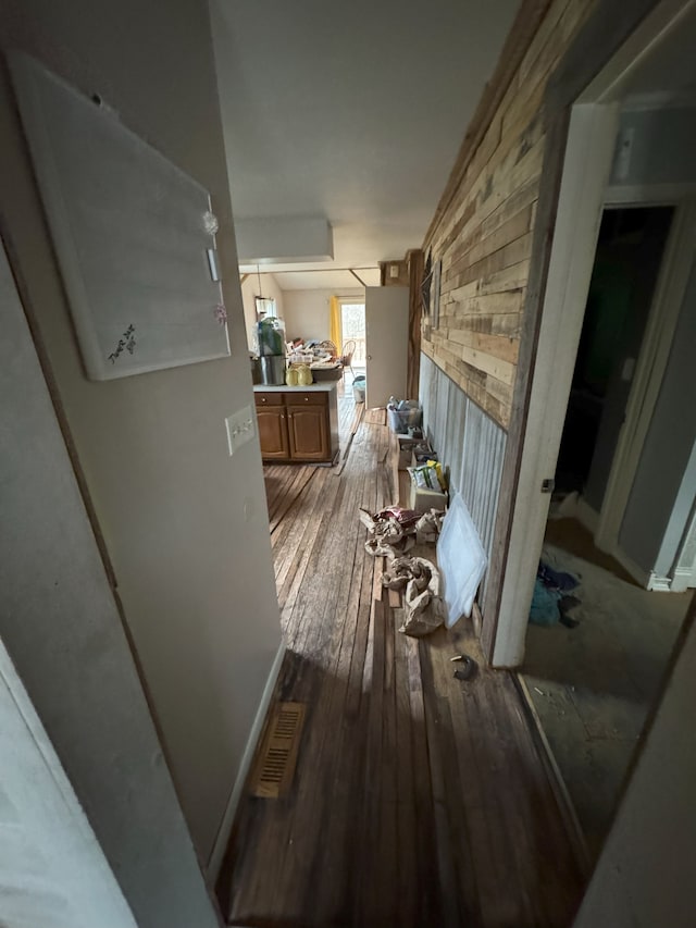 hall with visible vents and hardwood / wood-style floors