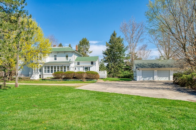 11811 Laird Rd, Brooklyn, MI 49230 - view of front of property with a chimney, a garage, and a front lawn